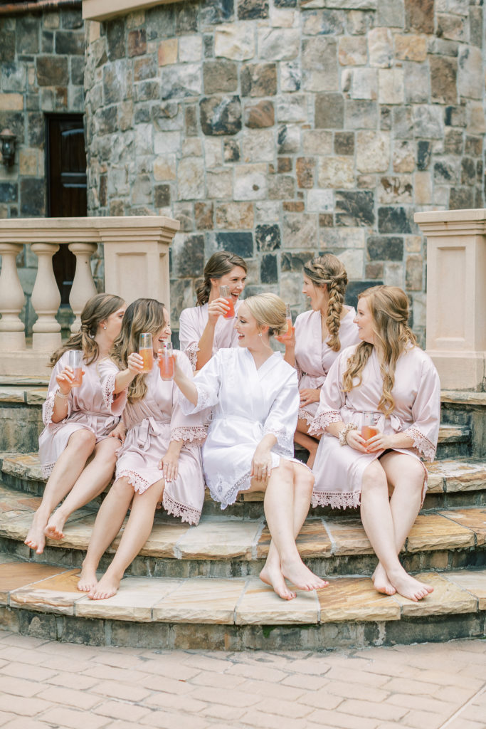 Bride and bridesmaids cheers in matching robes