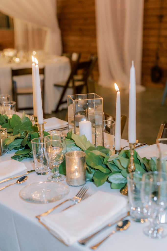 wedding tablescape with greenery garland and gold accents