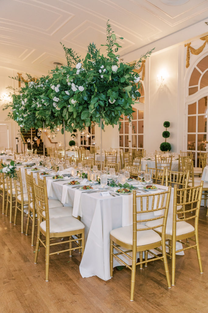 Head table with white floral centerpieces 