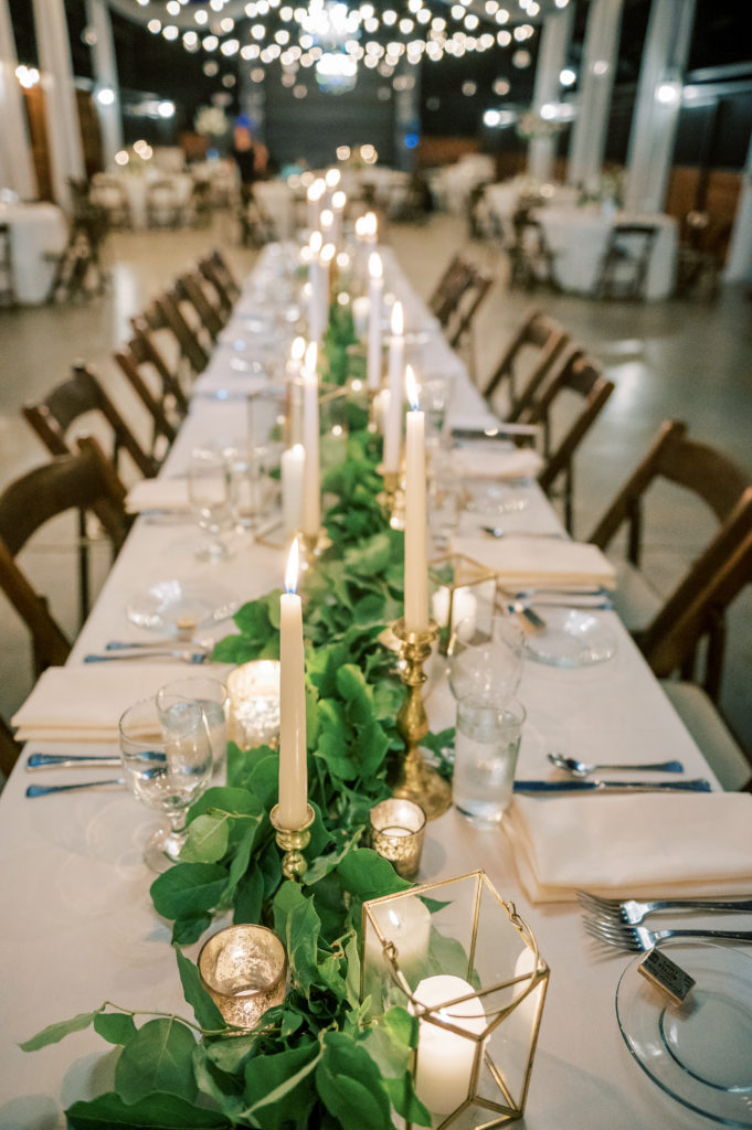 Indoor wedding reception with long tables at The Farm at High Shoals
