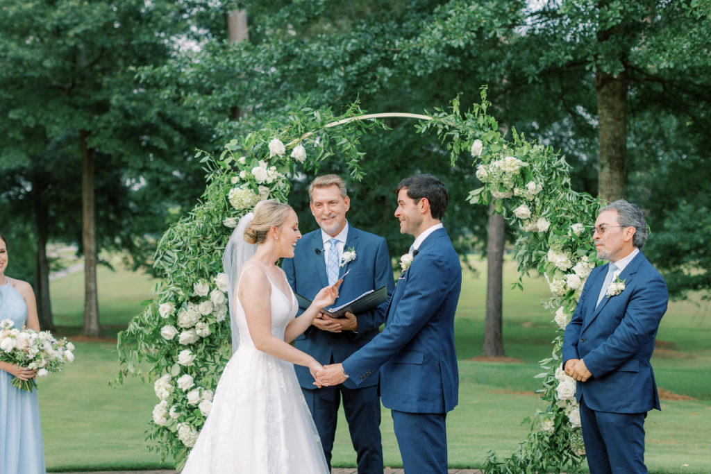bride reads vows to groom at outdoor ceremony at The Farm at High Shoals