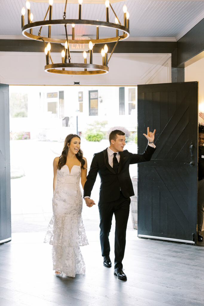 bride and groom entering wedding reception
