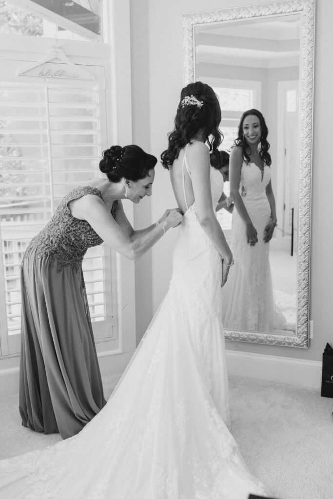 bride's mom helping her daughter get ready