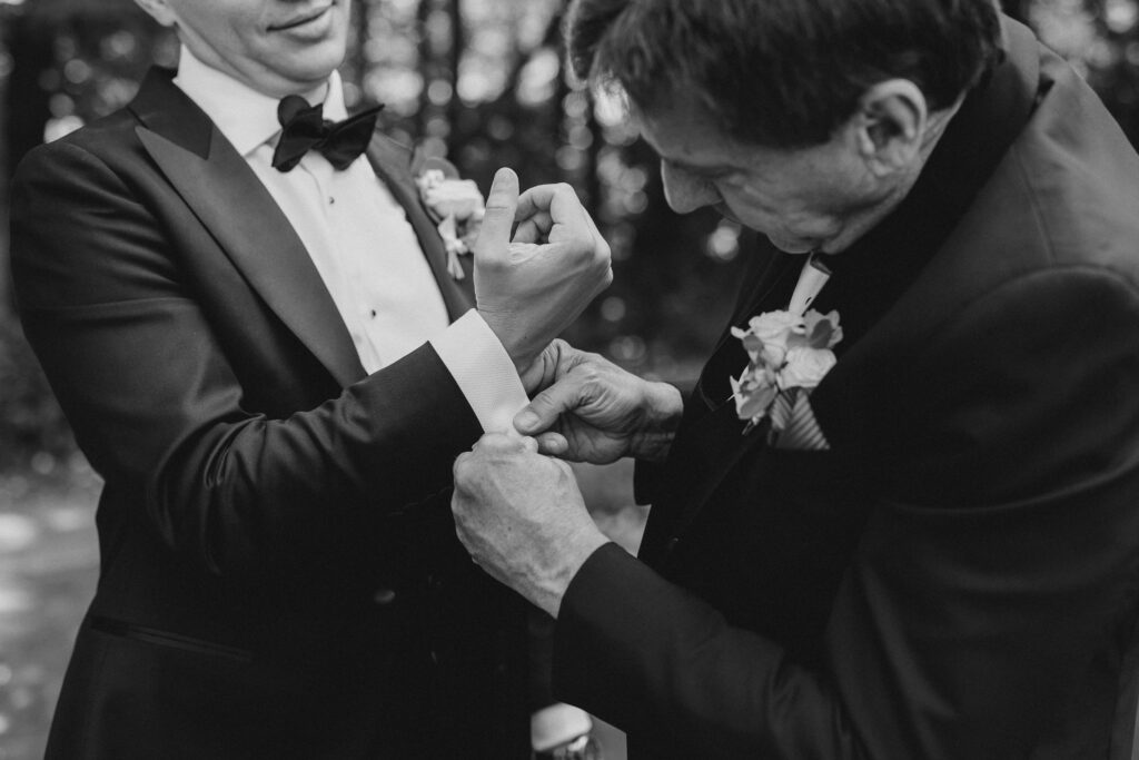 groom's father helping with cuff links