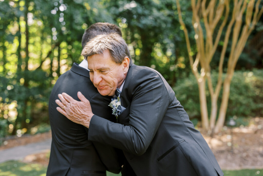 groom hugging his father