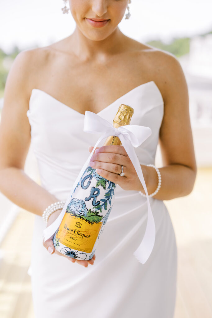 bride holding a bottle of champagne