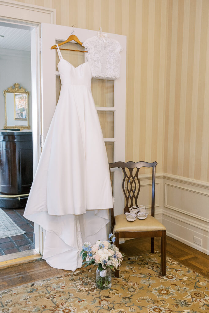 the bride's wedding gown hung in a doorway