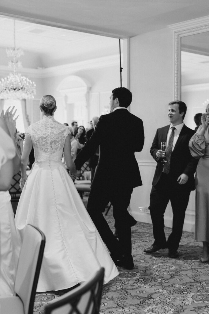 bride and groom entering their reception