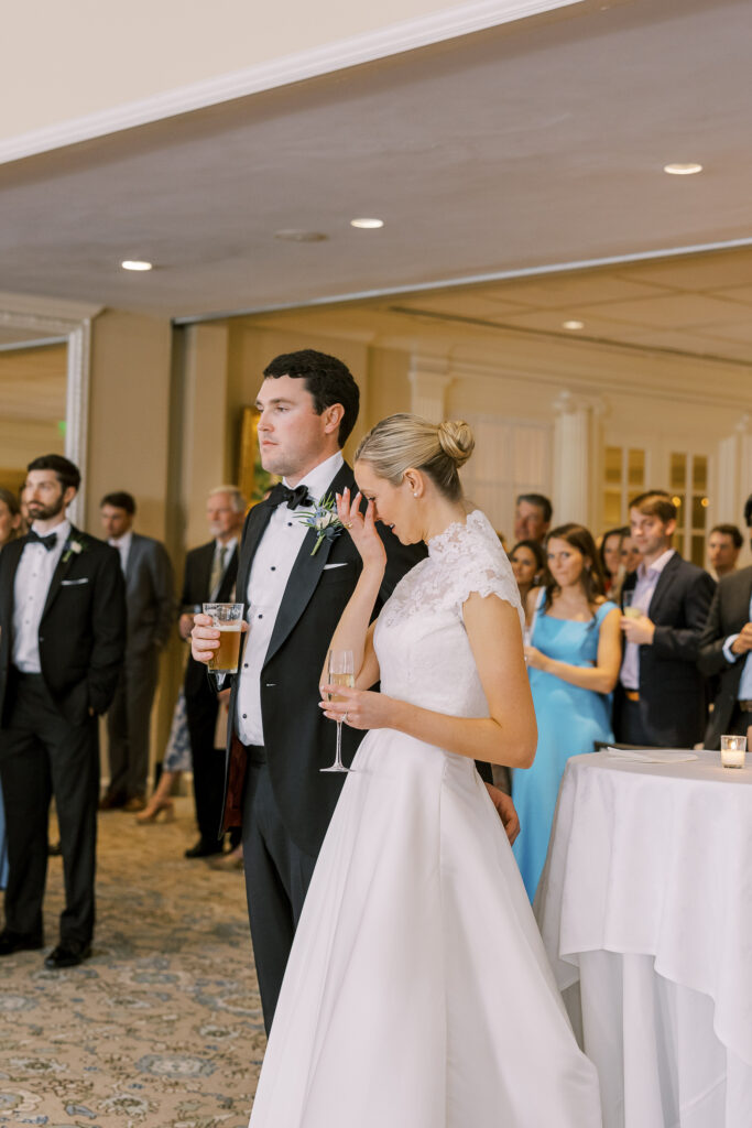 bride and groom listening to a toast