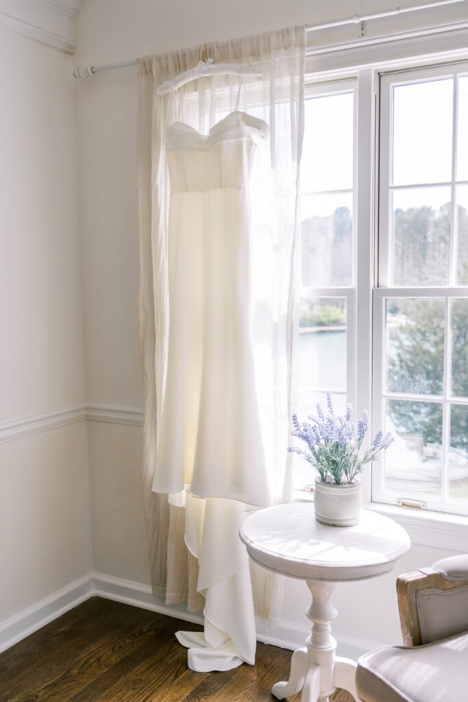 wedding dress hanging in the window