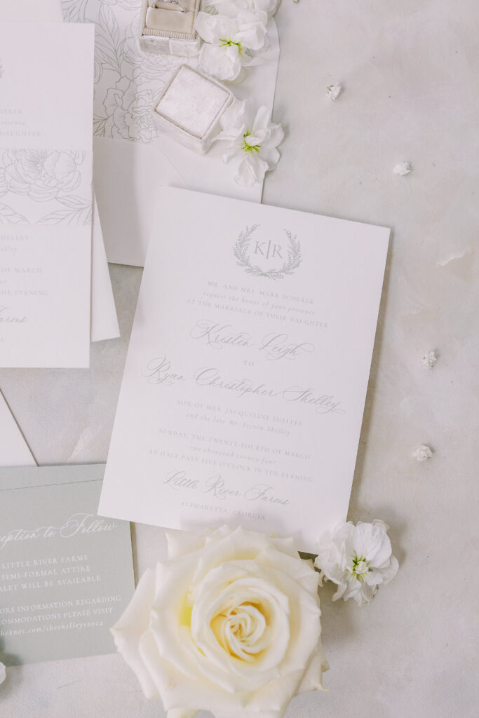 wedding invitations, roses, and wedding rings