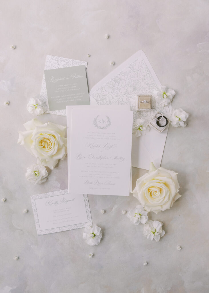 wedding invitations, roses, and wedding rings