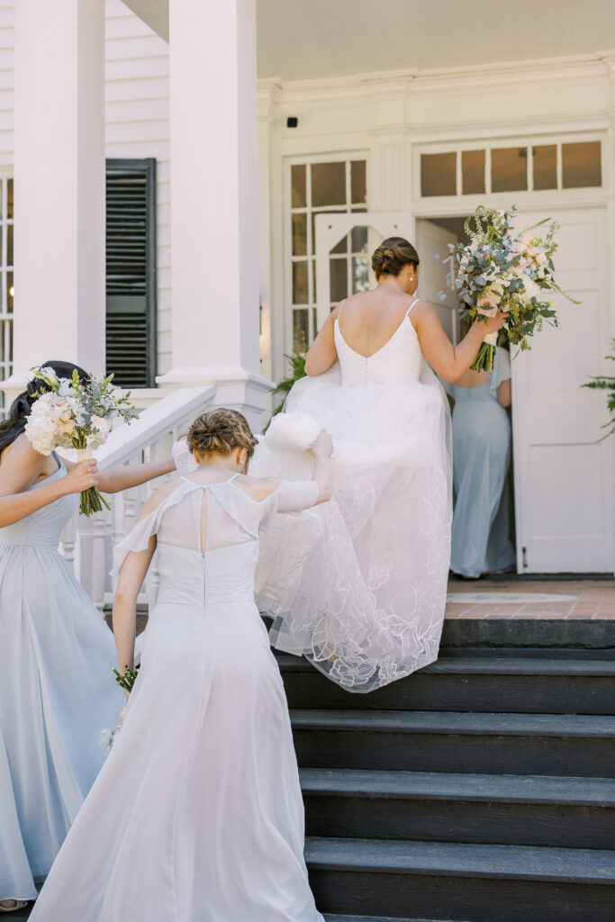 bride and her bridesmaids climbing stairs