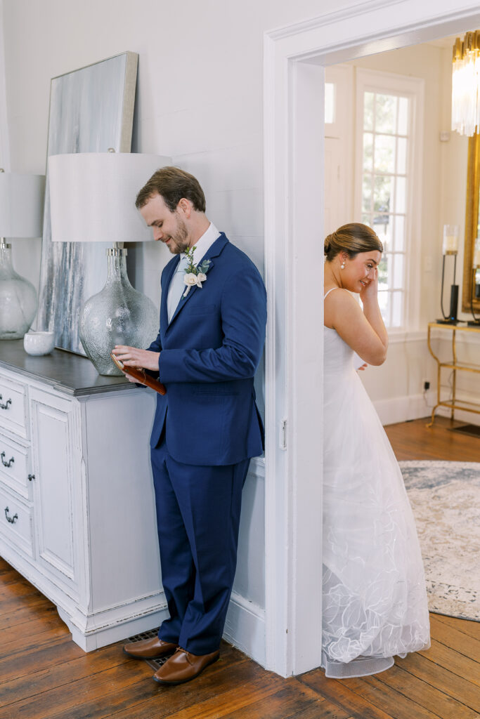 bride and groom reading vows around the corner from each other