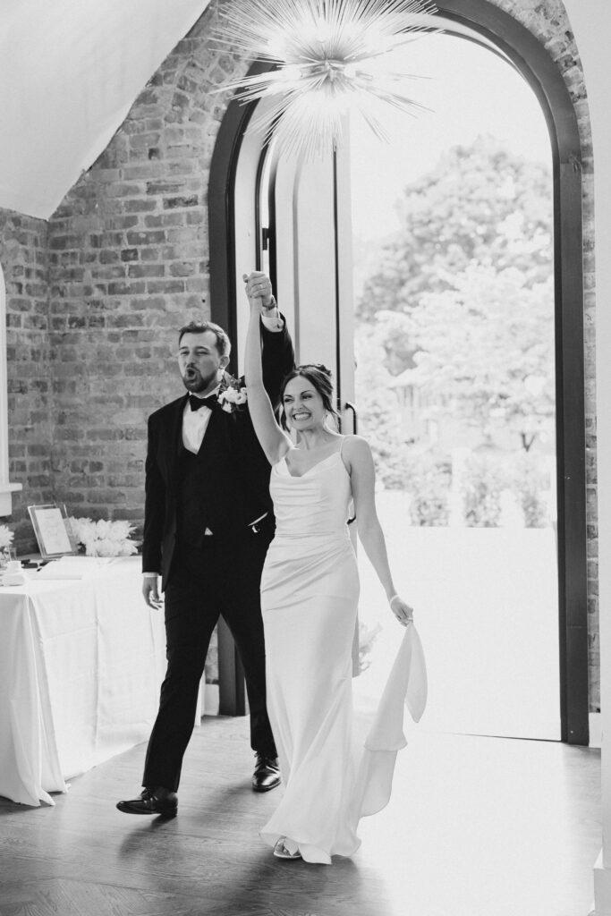 bride and groom entering wedding reception