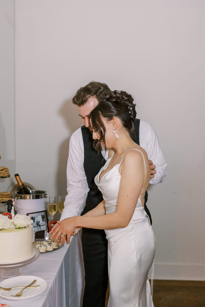 bride and groom cutting cake