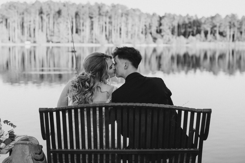 bride and groom kissing while fishing