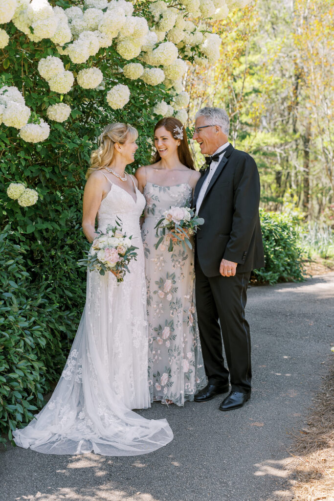 portrait of the bride, groom, and her daughter at the state botanical gardens of georgia in athens