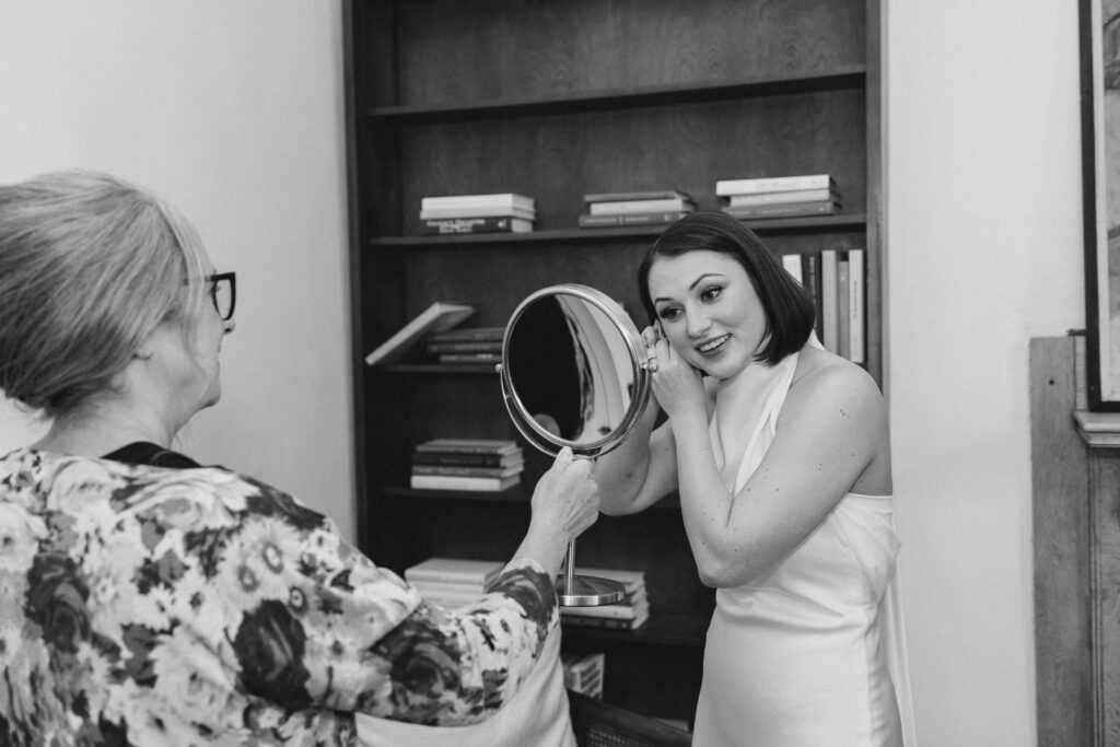 bride putting on her earrings