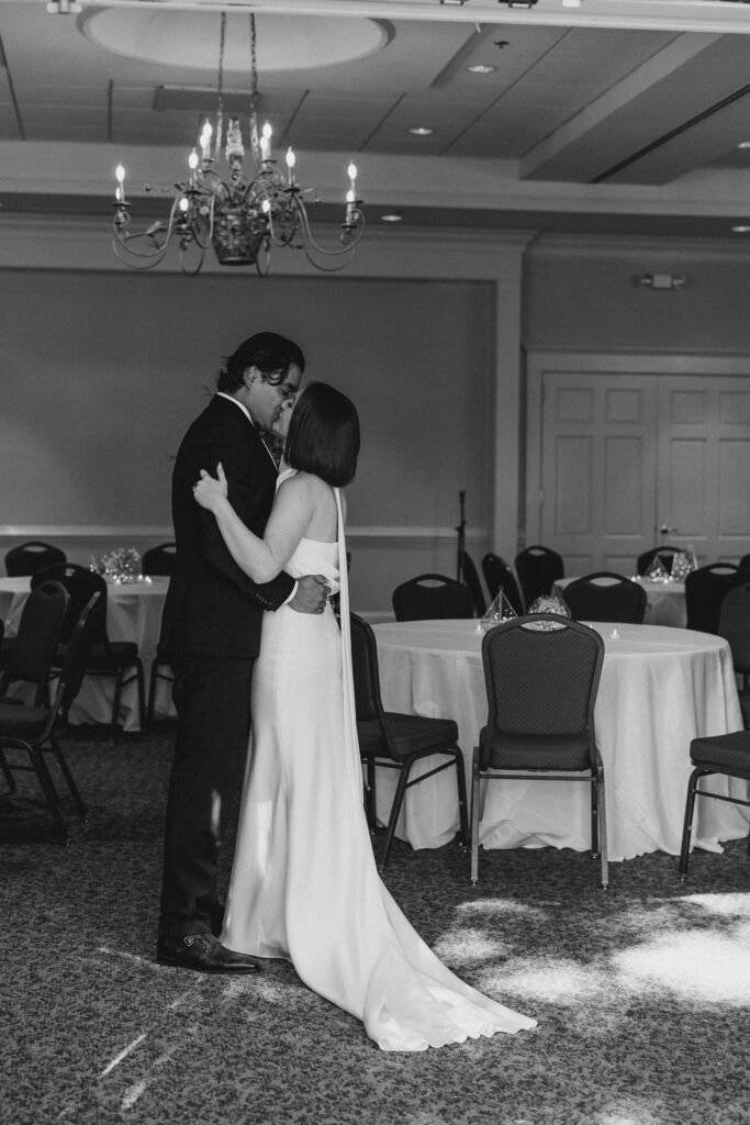 bride and groom kissing in the empty reception