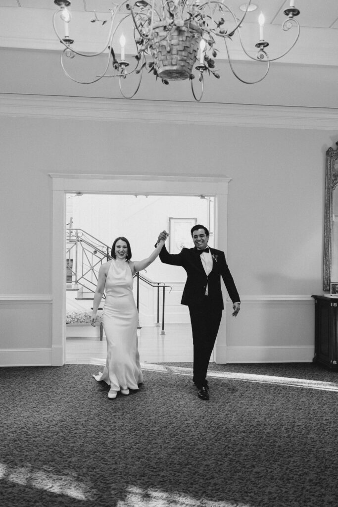 bride and groom entering their reception