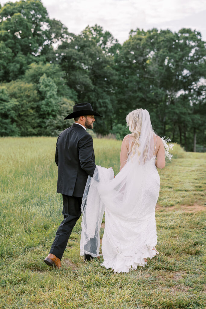 bride and groom with him holding her train