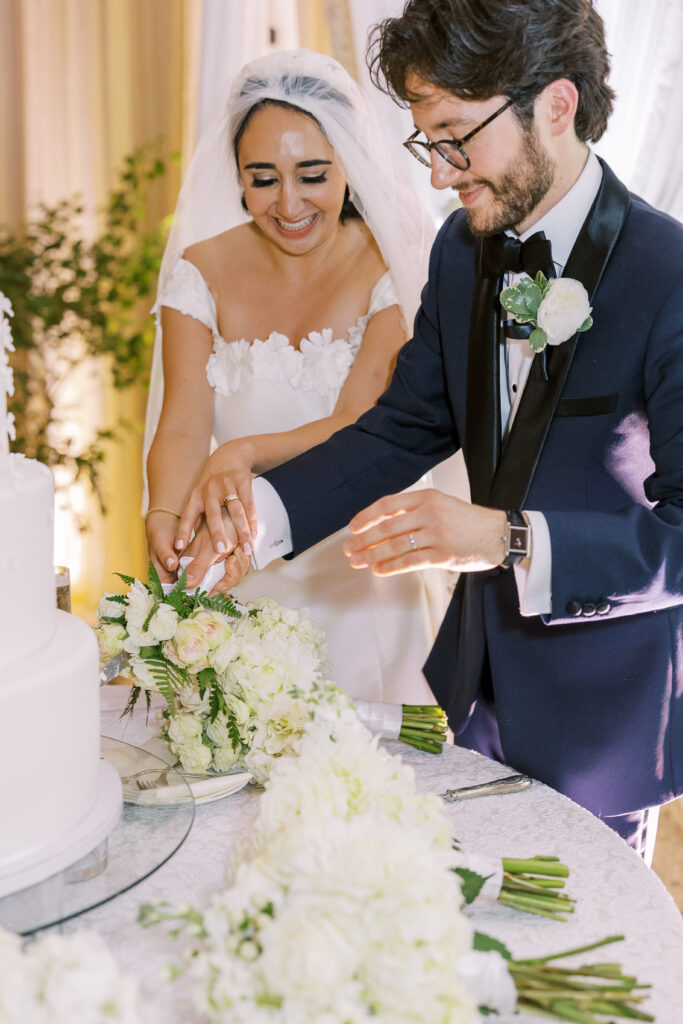 bride and groom cutting cake