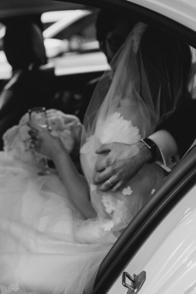 bride and groom leaving their wedding in a car