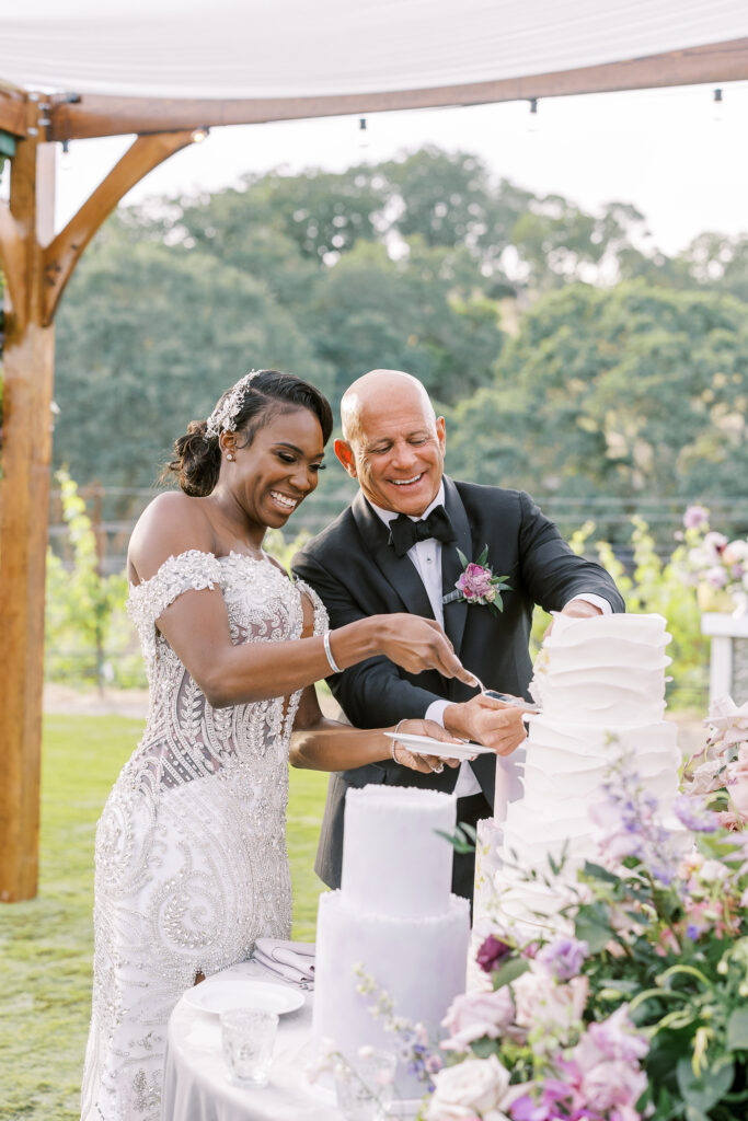 bride and groom cutting a cake featured in brides