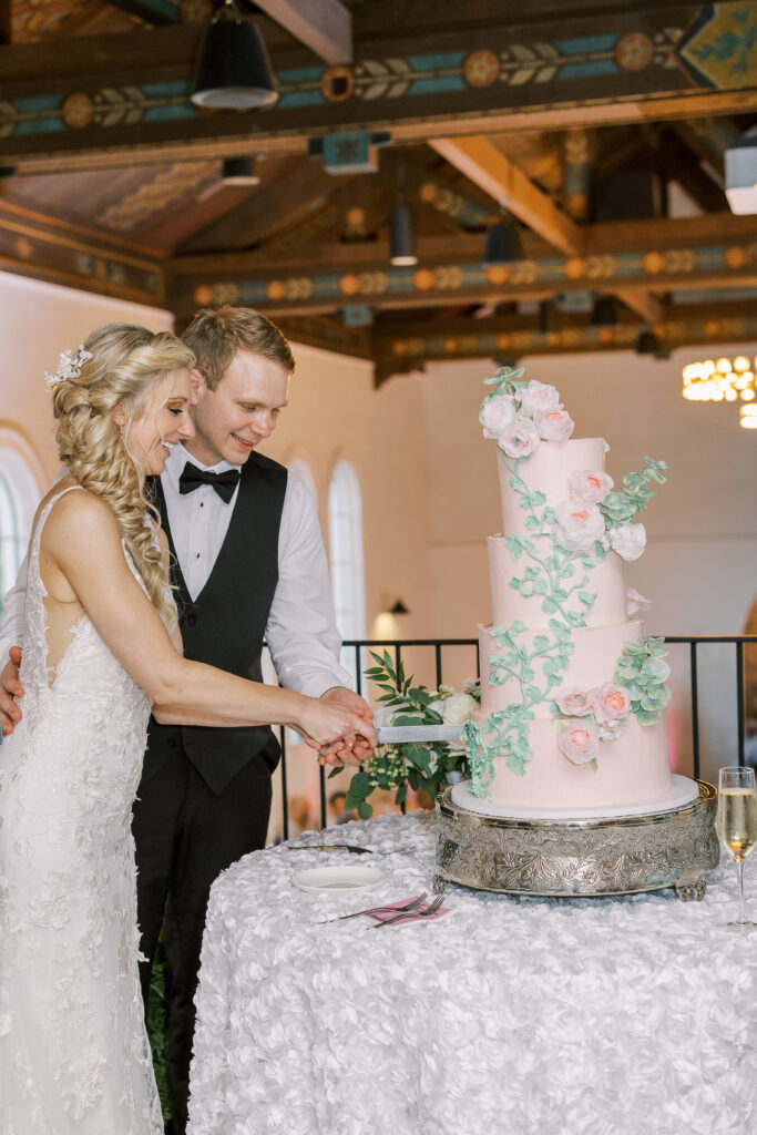 bride and groom cutting the cake