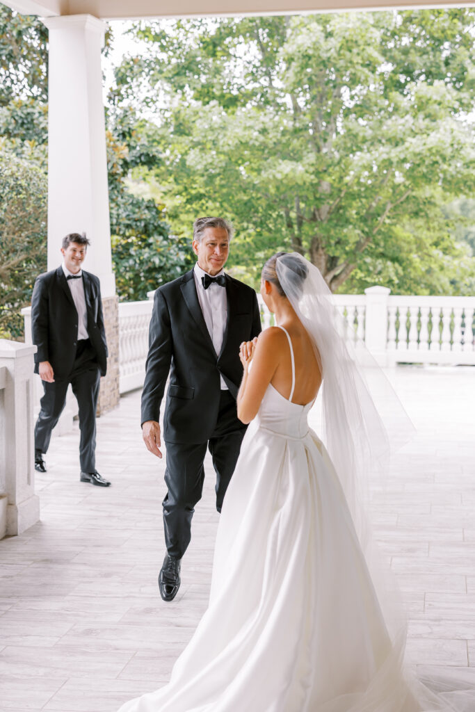 father and brother first look with bride