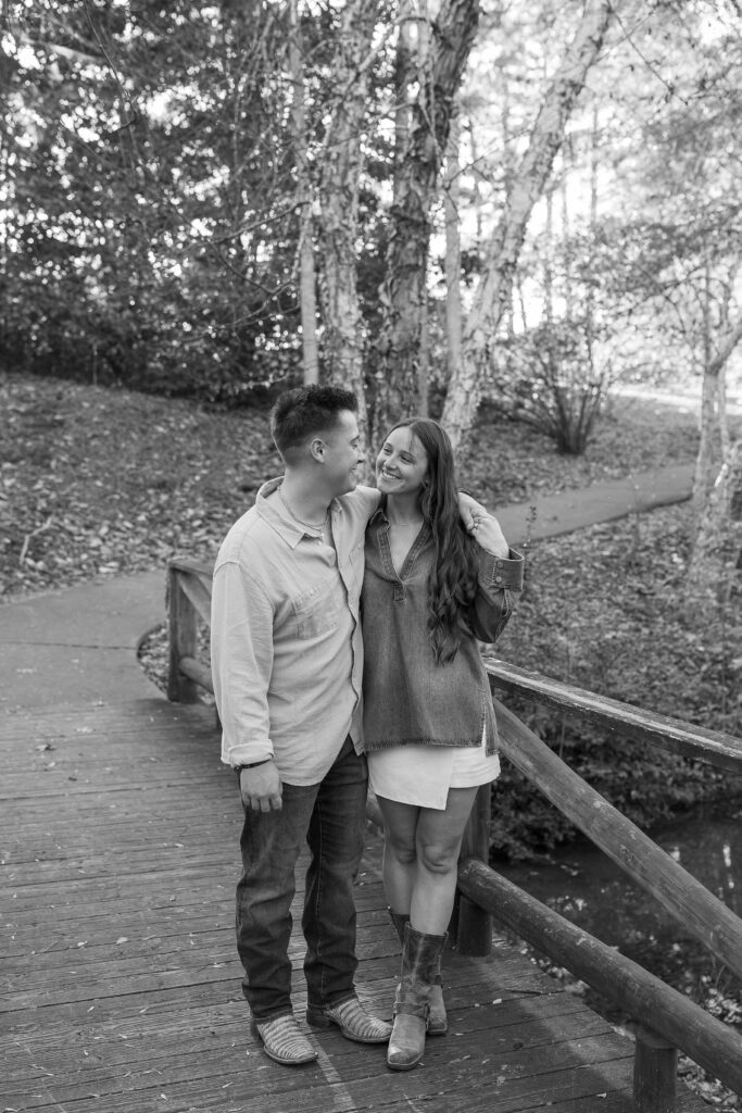 couple happy on a bridge in a park