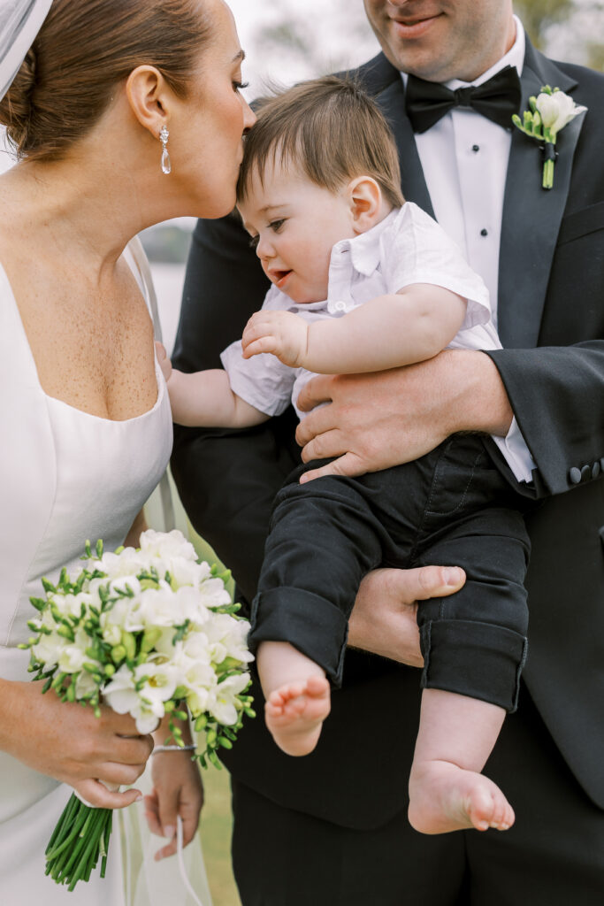 bride and groom first look with their son
