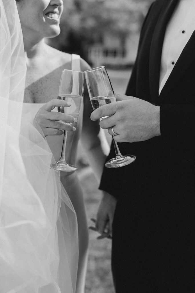 bride and groom drinking champagne