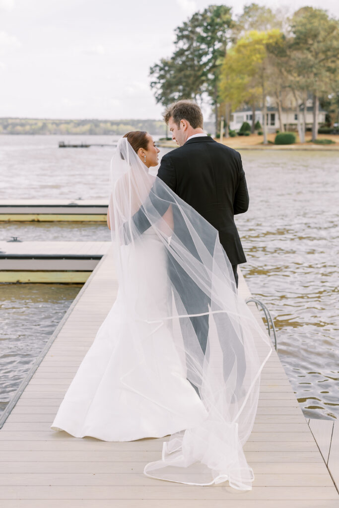 portrait of the bride and groom alongside the lake