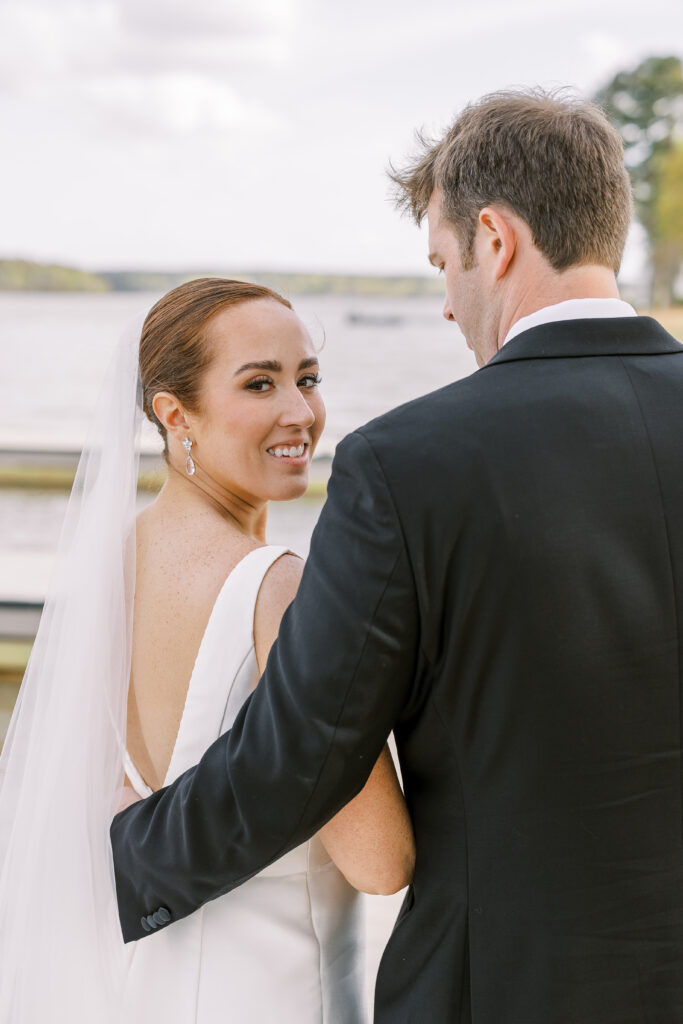 portrait of the bride and groom alongside the lake