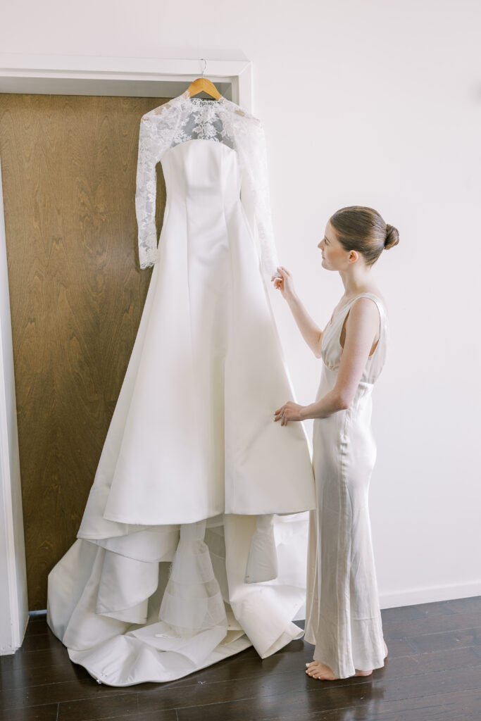 bride looking at her wedding dress