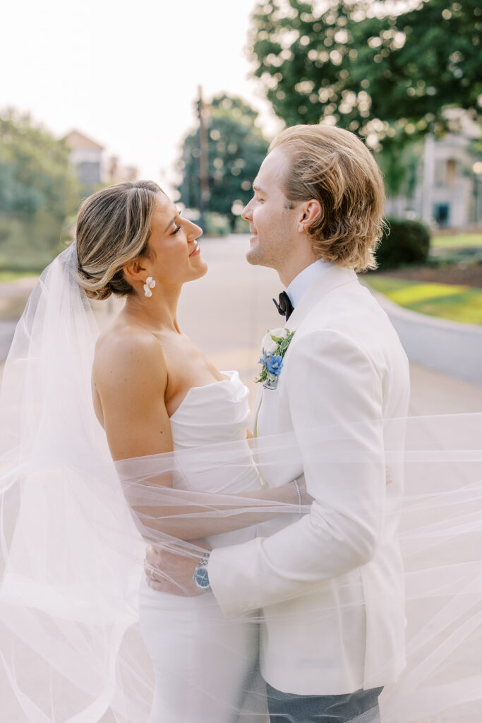 bride and groom behind veil at golden hour