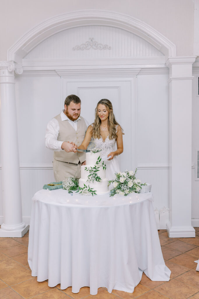 bride and groom cutting the cake