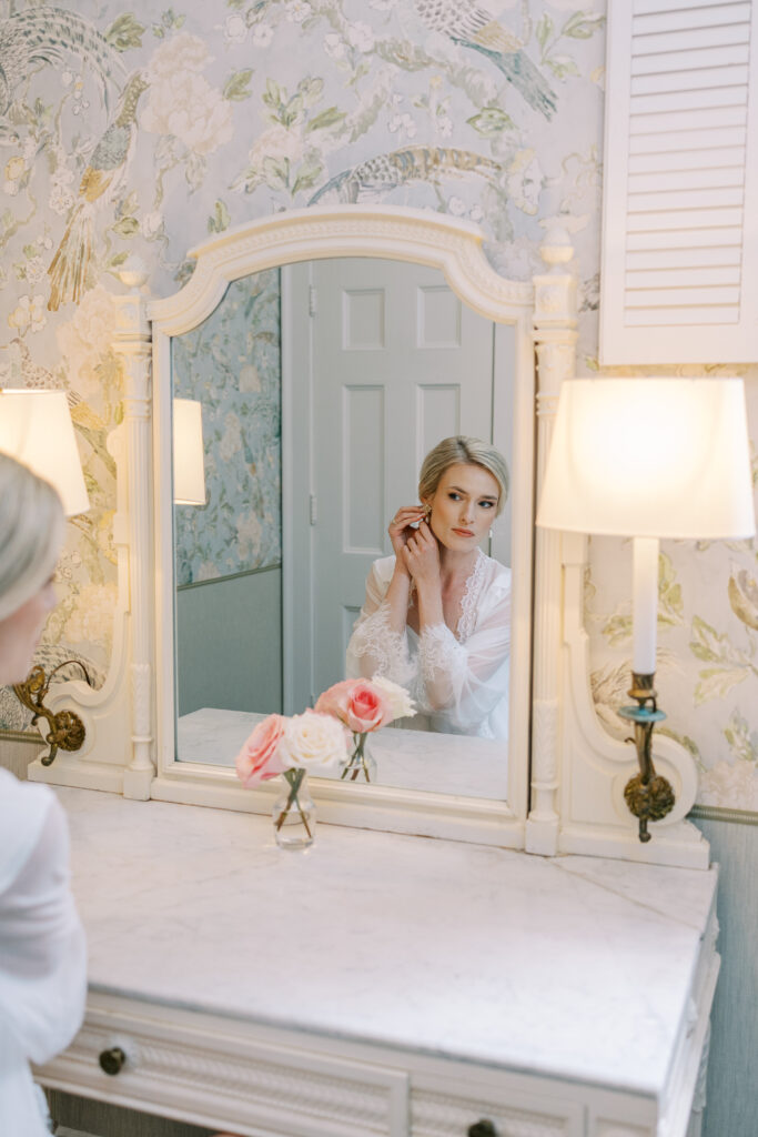 bride putting in earrings