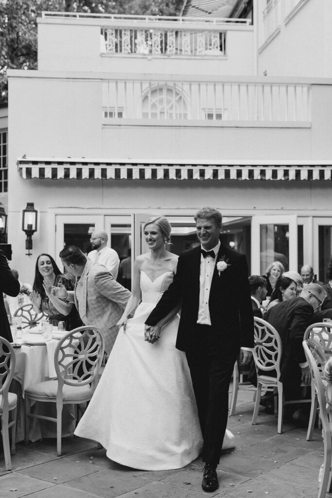 bride and groom entering their wedding reception