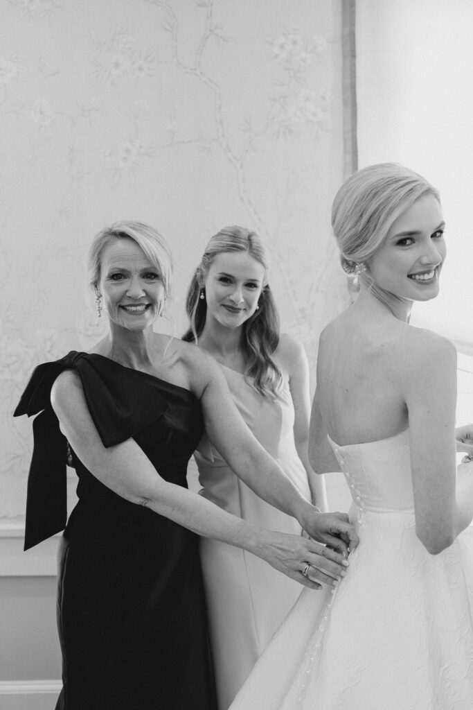 mom helping bride get dressed