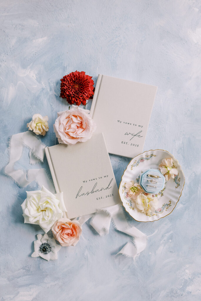 vow books with flowers and rings