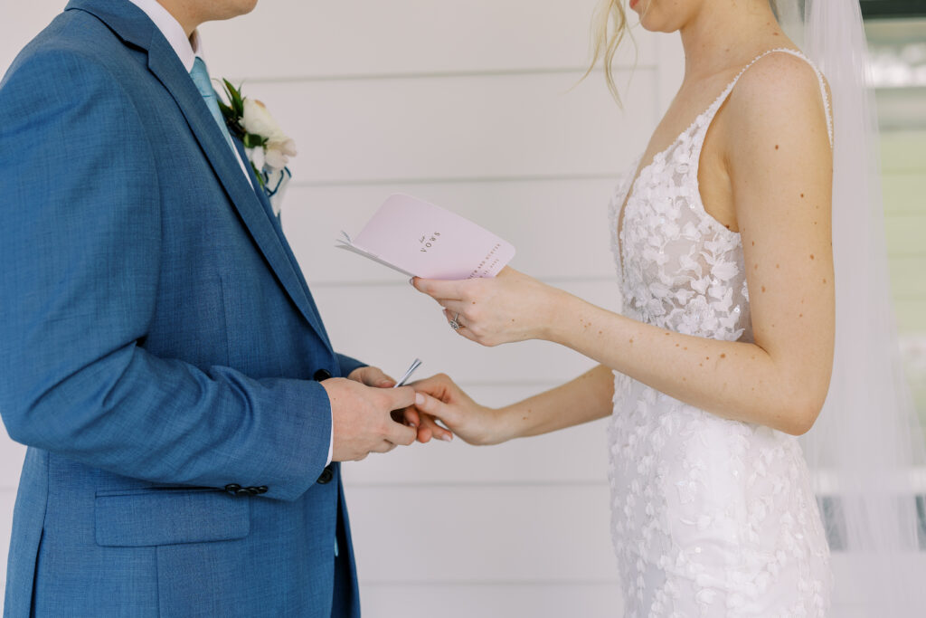 bride and groom reading vows