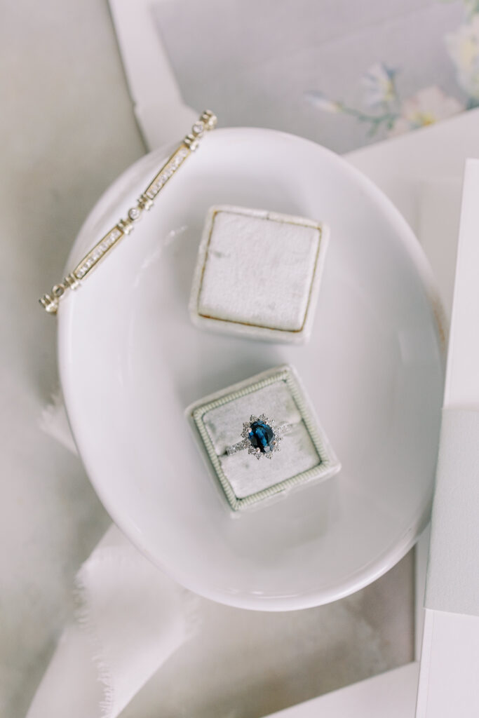 wedding detail flat lay including invitations and rings