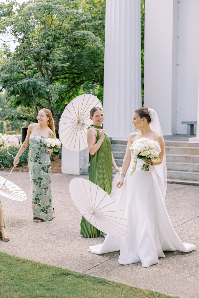 bride and bridesmaids with umbrellas