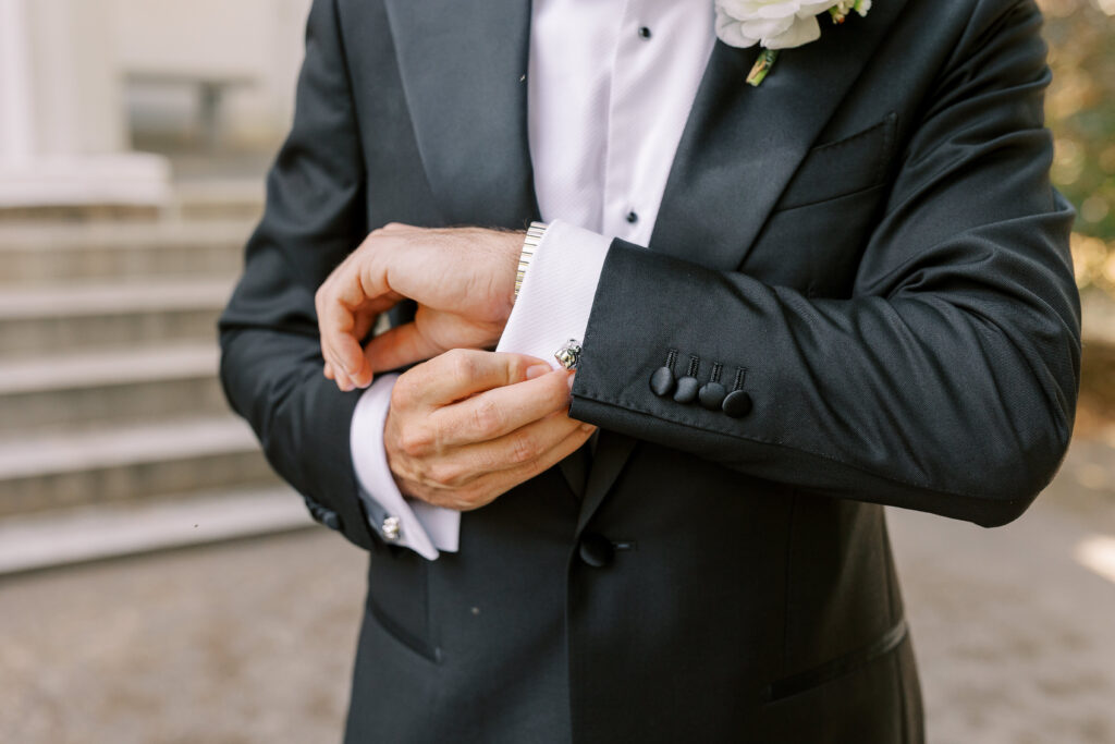 groom showing cufflink