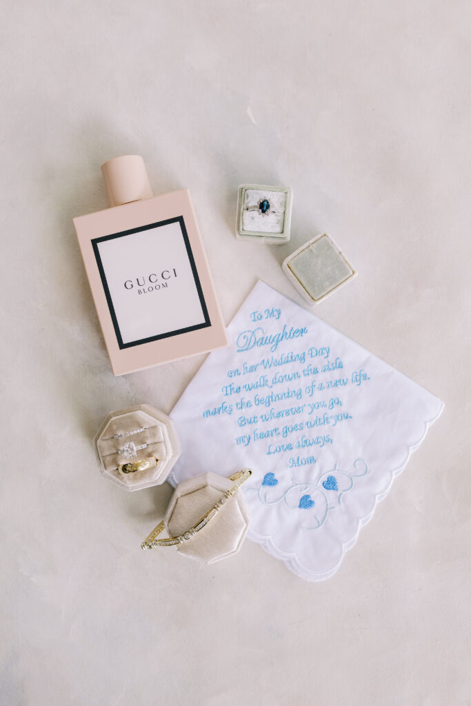 wedding detail flat lay including invitations and rings
