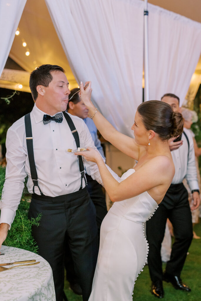 bride feeding the groom cake
