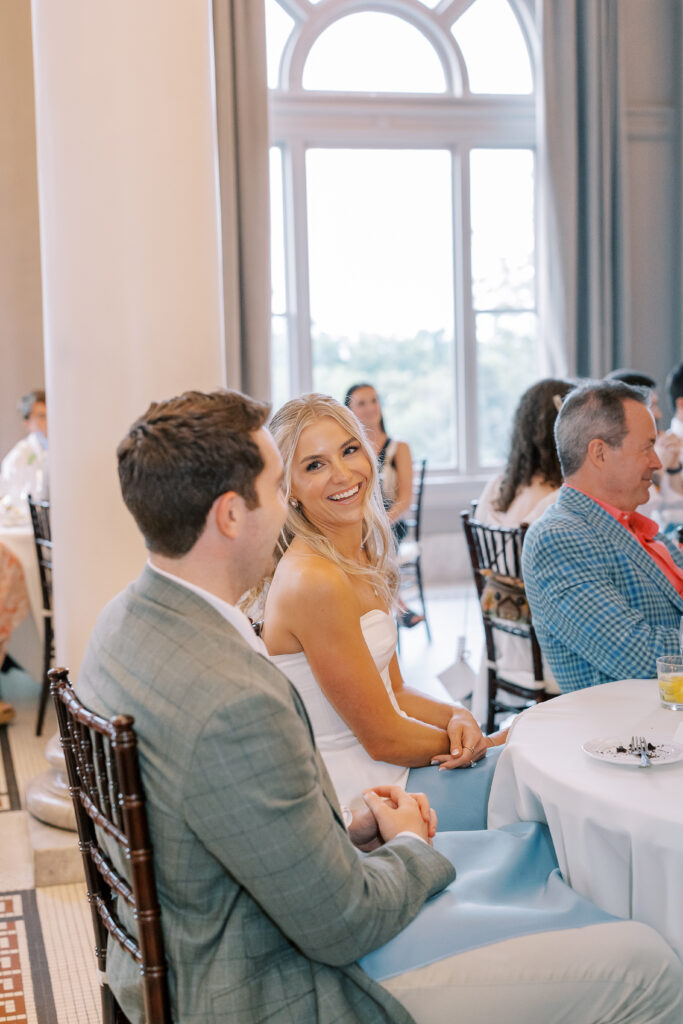 bride laughing while looking back at the groom